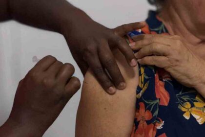 Profissional de saúde aplicando vacina em Unidade Básica de Saúde em Aracaju durante o Dia D