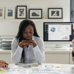 Profissional de RH e técnico de segurança do trabalho discutindo novos protocolos da NR-1.