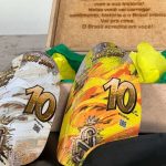 Par de caneleiras de alta performance personalizadas em tons de amarelo, branco e dourado com arte em grafite urbano e o logo NJR.